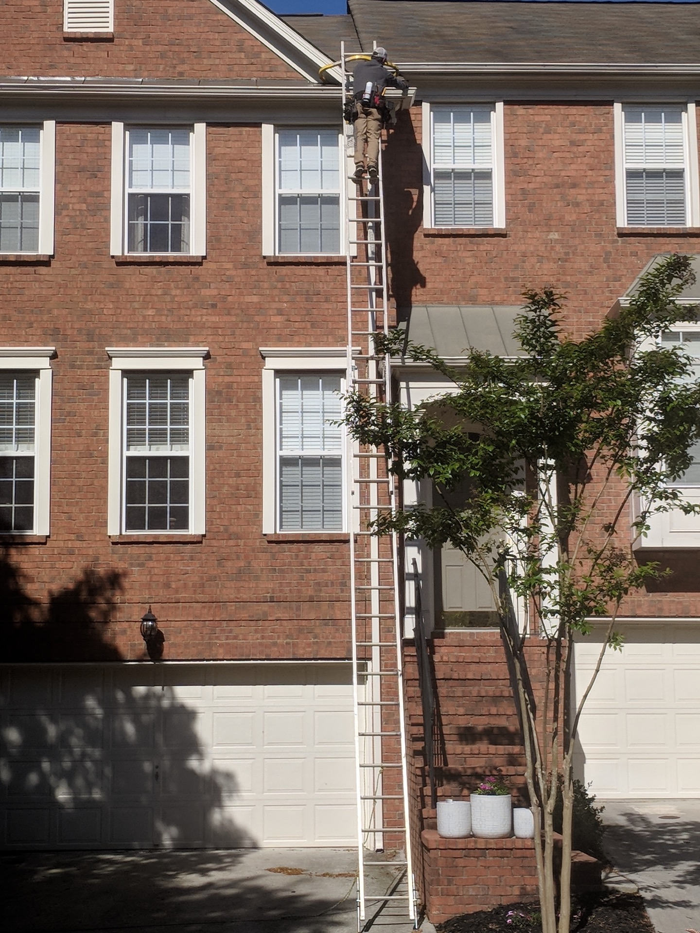 Wildlife exclusion contractor sealing soffit on a brick home in Shelby County